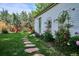 Beautiful backyard with manicured lawn, stone path, garden beds and thriving trees at 225 N Ivanhoe St, Denver, CO 80220