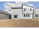 Modern home backyard with gray siding, large windows, and an unfinished yard at 9303 Biscay St, Commerce City, CO 80022