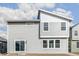 Modern home backyard with gray siding, large windows, and a sliding glass door for easy access to the outdoors at 9303 Biscay St, Commerce City, CO 80022