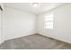 Bedroom featuring neutral carpet, white walls, baseboards, and a window for natural light at 9303 Biscay St, Commerce City, CO 80022