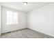 Well-lit bedroom featuring neutral carpet, a window providing plenty of light, and fresh white paint throughout at 9303 Biscay St, Commerce City, CO 80022