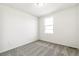 Bright bedroom featuring neutral carpet, a window providing plenty of light, and fresh paint throughout at 9303 Biscay St, Commerce City, CO 80022