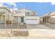 Charming two-story home featuring a covered porch, well-kept landscaping, and a two-car garage at 9303 Biscay St, Commerce City, CO 80022
