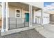 Inviting front porch with modern railings and a charming blue door welcomes you home at 9303 Biscay St, Commerce City, CO 80022