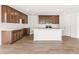 Modern kitchen featuring a large center island, stainless appliances and wood cabinets at 9303 Biscay St, Commerce City, CO 80022