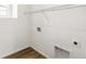 A bright laundry room features wood-look floors and convenient washer and dryer hookups at 9303 Biscay St, Commerce City, CO 80022
