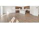 Spacious open floor plan featuring hardwood floors connecting to a modern kitchen at 9303 Biscay St, Commerce City, CO 80022