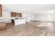 Open-concept living and kitchen area with lots of natural light shining on the hardwood floors at 9303 Biscay St, Commerce City, CO 80022