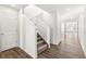 Entryway staircase with carpeted steps and hardwood floors at 9303 Biscay St, Commerce City, CO 80022