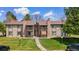 Two-story condo building with stone accents and well-maintained lawn offers a charming curb appeal at 1792 S Pitkin Cir # B, Aurora, CO 80017