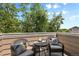 Balcony with patio seating and pillows surrounded by lush greenery at 6825 S Webster St # A, Littleton, CO 80128