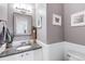 Stylish half bathroom with granite countertop and elegant framed mirror at 6825 S Webster St # A, Littleton, CO 80128