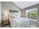 Cozy bedroom with soft lighting and a picture window at 6825 S Webster St # A, Littleton, CO 80128