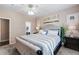 Comfortable bedroom features a large upholstered bed and carpeted floors at 6825 S Webster St # A, Littleton, CO 80128