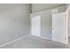 This bedroom features neutral gray walls, neutral carpet and a door to the closet and hallway at 6825 S Webster St # A, Littleton, CO 80128