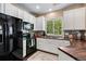 Kitchen area featuring sleek appliances, granite countertops, and a large window at 6825 S Webster St # A, Littleton, CO 80128