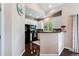 Cozy kitchen featuring white cabinets and black appliances at 6825 S Webster St # A, Littleton, CO 80128