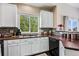 Kitchen area featuring granite countertops, white cabinets, and natural light at 6825 S Webster St # A, Littleton, CO 80128