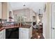 Living room view from kitchen featuring a fireplace and comfortable seating at 6825 S Webster St # A, Littleton, CO 80128