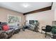 This living room has a large window, a wooden support beam and neutral carpet at 6825 S Webster St # A, Littleton, CO 80128