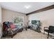 This living room has a large window, a wooden support beam and neutral carpet at 6825 S Webster St # A, Littleton, CO 80128
