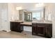 Elegant bathroom featuring double vanities, granite countertops, and a large mirror at 9486 Juniper Way, Arvada, CO 80007