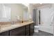 Bathroom featuring double sinks, granite countertops, and a shower-tub combo with modern fixtures at 9486 Juniper Way, Arvada, CO 80007