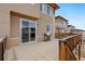 Large deck with space for outdoor dining and grilling, perfect for entertaining with a glass slider entry to interior at 9486 Juniper Way, Arvada, CO 80007