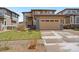 Charming two-story home featuring a manicured lawn, two-car garage, and stone accents at 9486 Juniper Way, Arvada, CO 80007