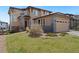 Attractive two-story home featuring a two-car garage, well-manicured lawn and stylish stone accents at 9486 Juniper Way, Arvada, CO 80007