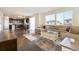 Bright open concept living room featuring hardwood floors, large windows, and comfortable seating at 9486 Juniper Way, Arvada, CO 80007