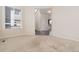 Bright living room with neutral carpet, offers a glimpse into the stairwell and open layout at 9486 Juniper Way, Arvada, CO 80007
