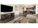 Open concept living room showcasing hardwood floors, seamlessly transitioning into the dining and kitchen areas at 9486 Juniper Way, Arvada, CO 80007