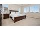 Relaxing main bedroom with large windows, plush carpeting, and a comfortable king-sized bed at 9486 Juniper Way, Arvada, CO 80007