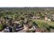 Sweeping aerial view of a residential neighborhood with mature trees, a park, and glimpses of the city skyline at 4374 E Peakview Cir, Centennial, CO 80121