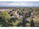 Expansive aerial view of a residential neighborhood showcasing tree-lined streets, well-maintained homes, and mountain views at 4374 E Peakview Cir, Centennial, CO 80121