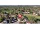 Sweeping aerial view of a residential neighborhood with mature trees, a park, and glimpses of the city skyline, marked with an 'R' icon at 4374 E Peakview Cir, Centennial, CO 80121