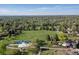 Wide aerial view showcasing a neighborhood, a park with sports fields, and distant cityscape views at 4374 E Peakview Cir, Centennial, CO 80121