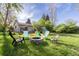 Charming backyard features a stone fire pit surrounded by Adirondack chairs, offering a cozy outdoor retreat at 4374 E Peakview Cir, Centennial, CO 80121