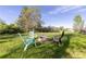 Inviting backyard with a stone fire pit, colorful Adirondack chairs, and mature trees, perfect for outdoor entertaining at 4374 E Peakview Cir, Centennial, CO 80121