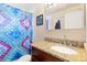 Bathroom with a granite countertop sink, a colorful curtain and a large mirror at 4374 E Peakview Cir, Centennial, CO 80121
