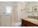 Well lit bathroom featuring a glass shower, granite counter tops, and a large mirror at 4374 E Peakview Cir, Centennial, CO 80121