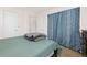 A bedroom with a queen-sized bed and large, patterned curtains covering the closet at 4374 E Peakview Cir, Centennial, CO 80121