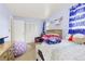 A cozy bedroom with carpet, and two windows, and a double-doored closet at 4374 E Peakview Cir, Centennial, CO 80121