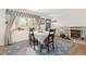 Bright dining room featuring hardwood floors and a large window with sunlight spilling across the area rug at 4374 E Peakview Cir, Centennial, CO 80121