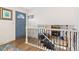 Entryway leading to a cozy living room with a fireplace and comfortable seating, with railing accents at 4374 E Peakview Cir, Centennial, CO 80121