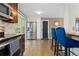 Modern kitchen with stainless steel appliances, a large refrigerator, breakfast bar seating, and a sliding door to the outside at 4374 E Peakview Cir, Centennial, CO 80121