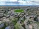 Aerial view highlighting the neighborhood, a green sports field, and surrounding roads and buildings at 6544 E Alaska Dr, Denver, CO 80224