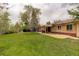 Enjoy the expansive backyard with a brick house and covered patio, perfect for outdoor entertaining at 6544 E Alaska Dr, Denver, CO 80224