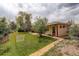 The spacious backyard features mature trees, grass, a patio and easy access to the home's back door at 6544 E Alaska Dr, Denver, CO 80224
